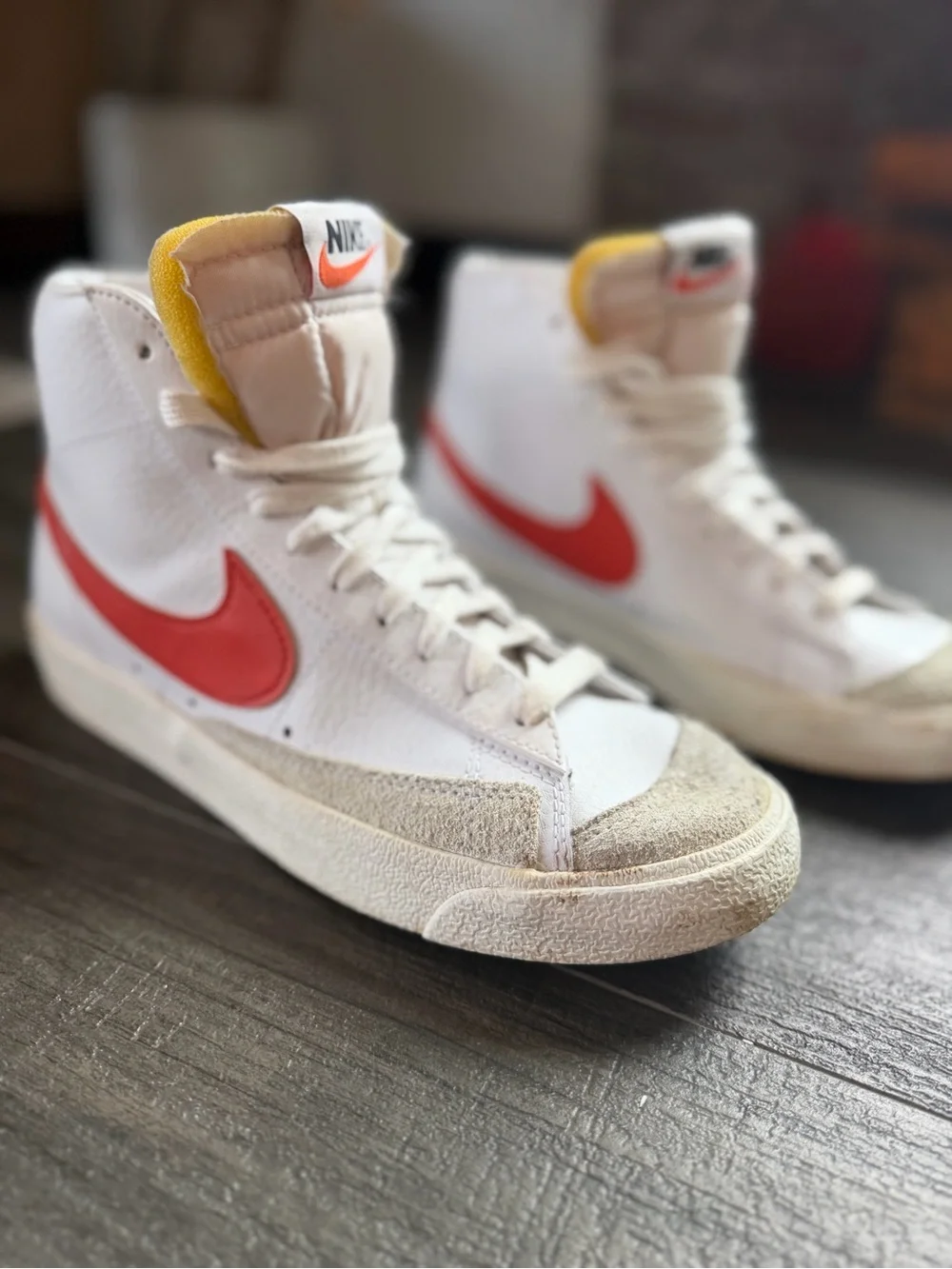 Nike Woman’s White High-Top Sneakers with Red Swoosh